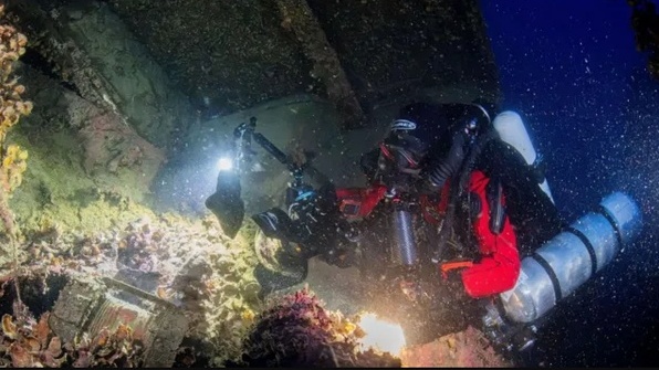 A diver photographs the wreckage of the HMHS Britannic during a recovery operation