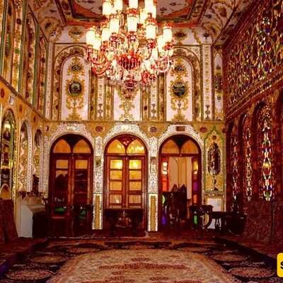 The illuminated Motamedi House in Isfahan, With its Wooden Doors, Colorful Glass Windows, and Authentic Iranian Decor, Will Captivate Your Eyes.