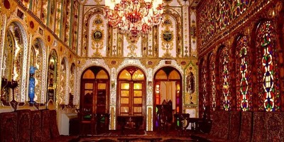 The illuminated Motamedi House in Isfahan, With its Wooden Doors, Colorful Glass Windows, and Authentic Iranian Decor, Will Captivate Your Eyes.