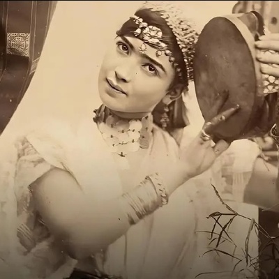 TwoPaintings by Naser al-Din Shah Qajar of a Beautiful European Woman Beside an Iranian Samovar, Pouring Tea, Wearing a Boat-neck Blouse and a Puffed Skirt / dated 1263 (1884-1885 CE).